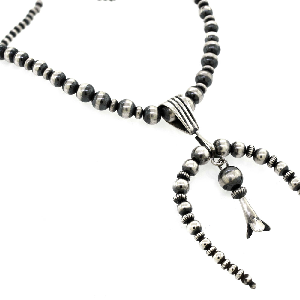 
                  
                    A Super Silver Handcrafted Naja Beaded Necklace, offering protection.
                  
                