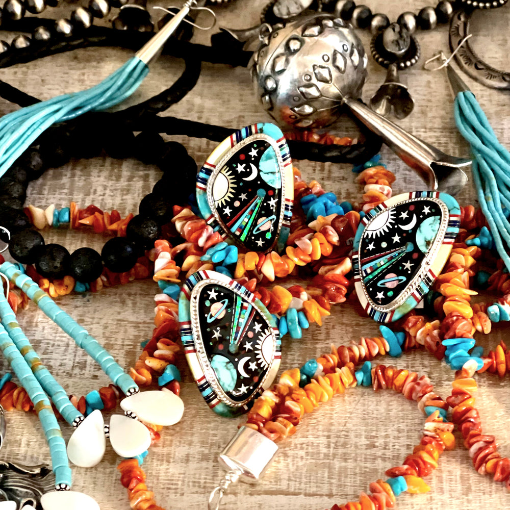 
                  
                    A table full of Super Silver's Handmade Spiny Oyster Shell and Turquoise Necklaces, spiny oyster shell bracelets, and beads.
                  
                