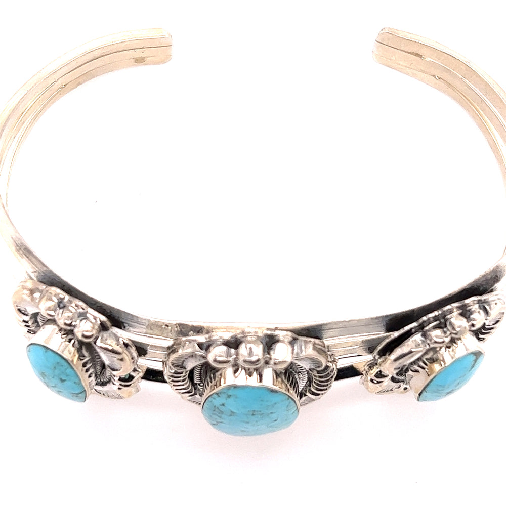 
                  
                    A stunning Super Silver Native American Cuff with Three Stunning Turquoise Stones bracelet.
                  
                