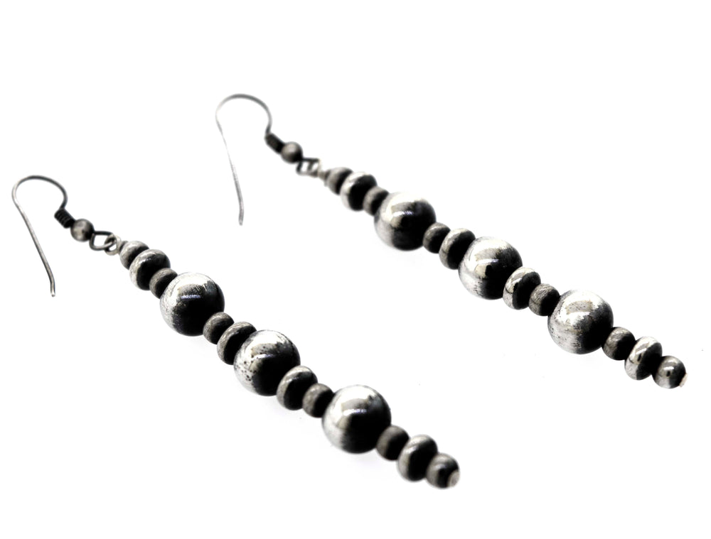 A pair of Long Handcrafted Navajo Pearl Earrings with an oxidized finish, showcased against a white background, offered by Super Silver.
