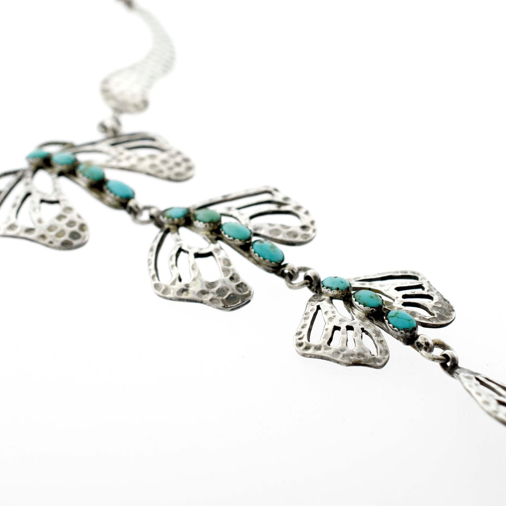 
                  
                    A Super Silver Handmade Turquoise Dragonfly Necklace And Earring Set adorned with delicate butterfly charms.
                  
                