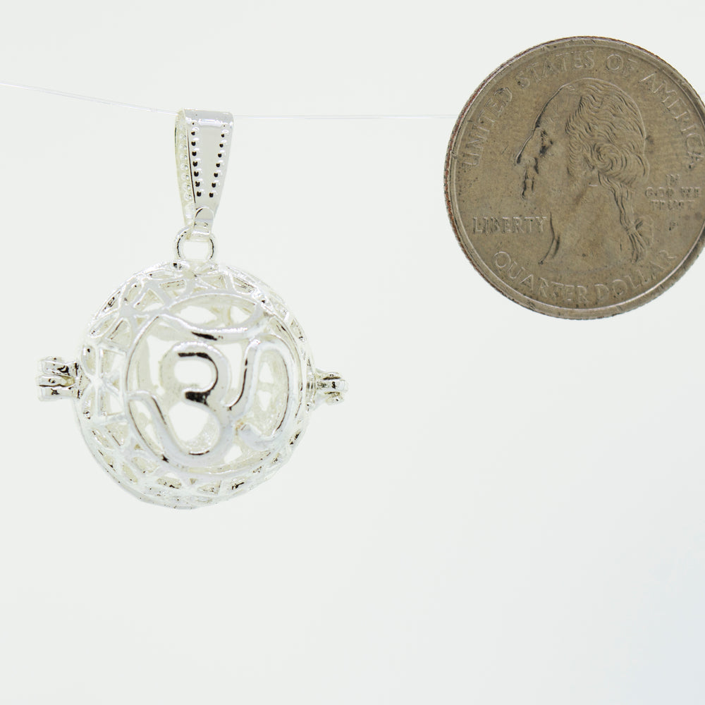 
                  
                    A Super Silver Om Cage Pendant with a special keepsake penny.
                  
                