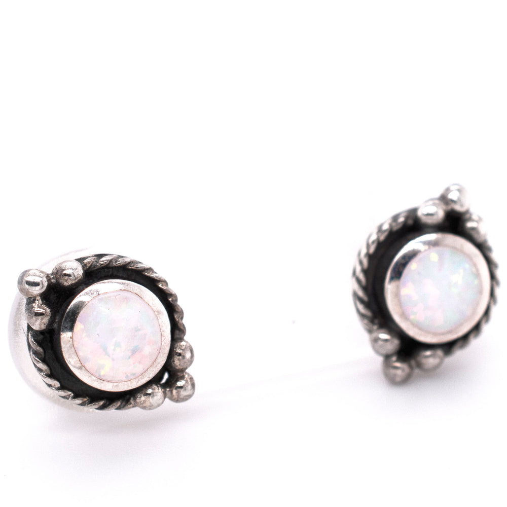 
                  
                    Description: Super Silver Bali style opal stud earrings featuring white opal with oxidized rope detailing, showcased on a white background.
                  
                
