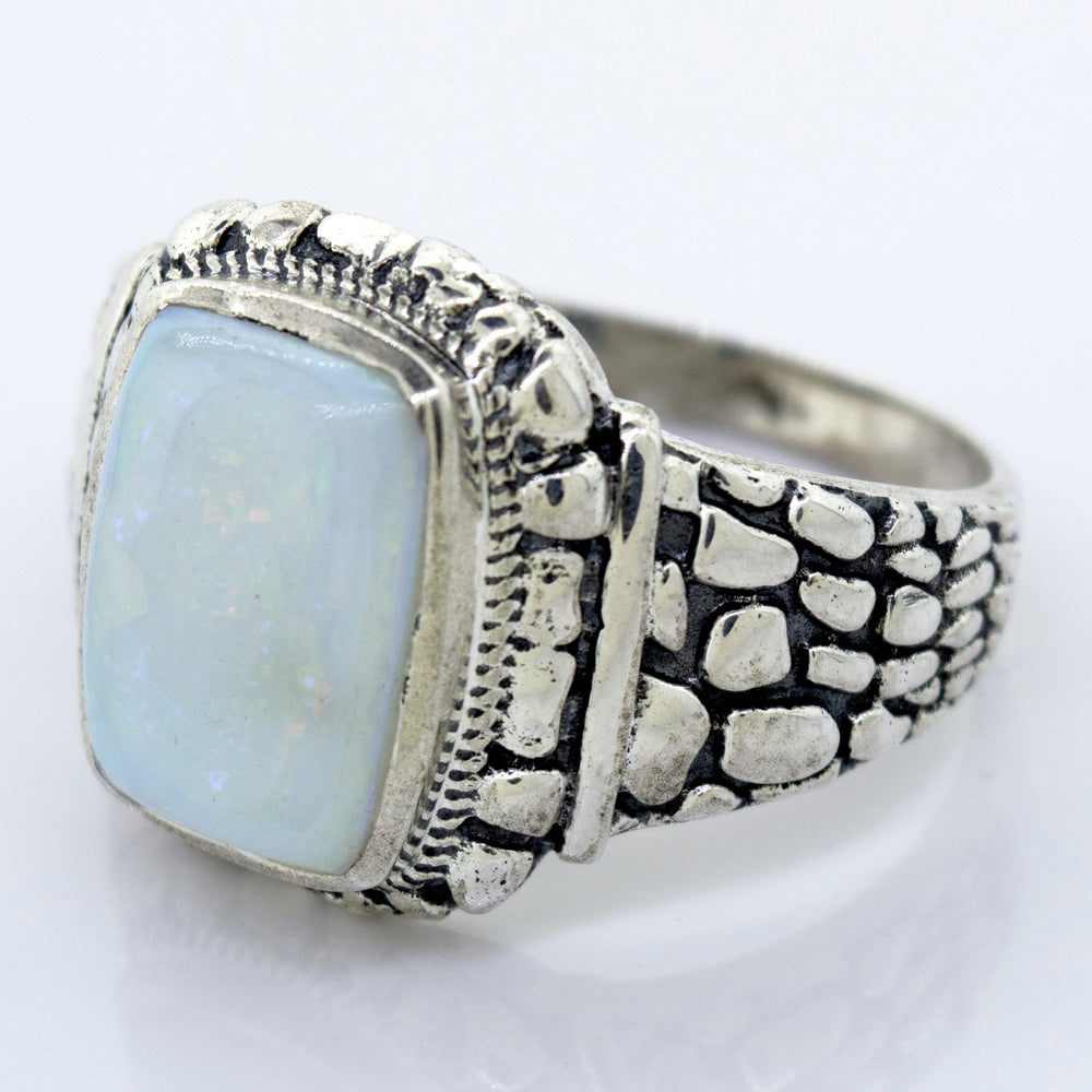 
                  
                    A minimalist silver ring with an Australian Opal Signet Ring With Dragon Scale Pattern.
                  
                