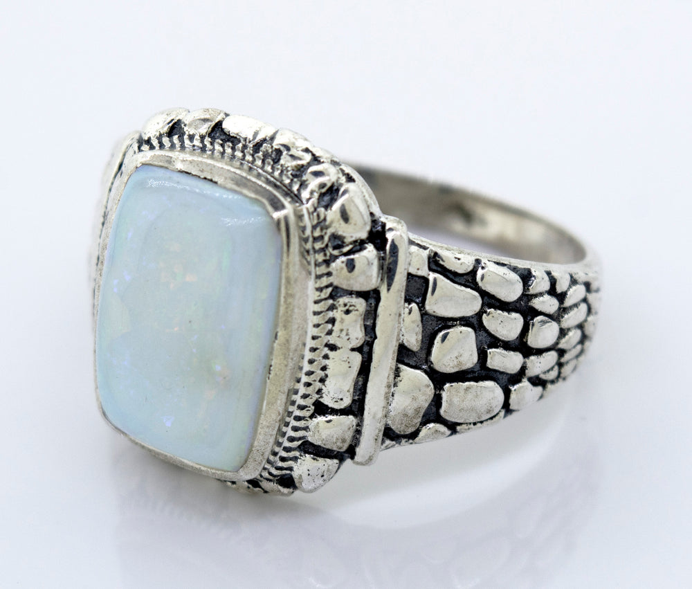 A minimalist silver ring with an Australian Opal Signet Ring With Dragon Scale Pattern.