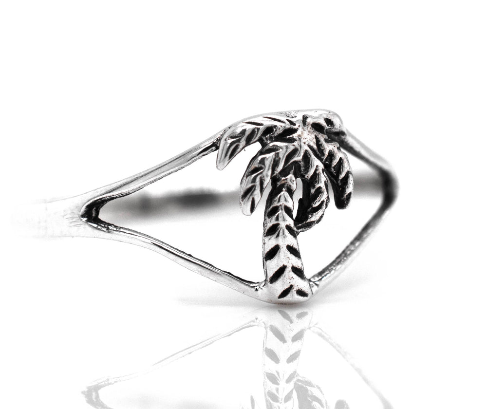 
                  
                    A sterling silver Delicate Palm Tree Ring, perfect for beach lovers.
                  
                