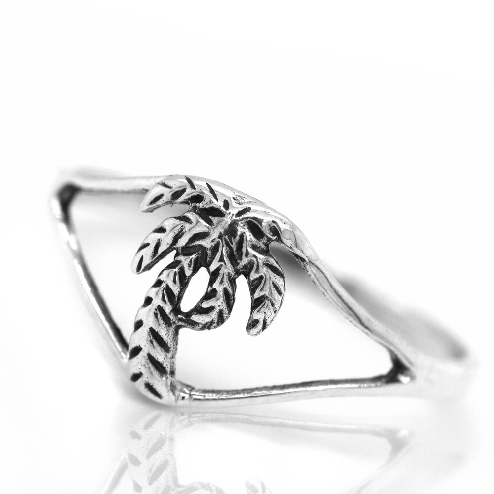 
                  
                    A delicate palm tree ring with a palm tree on it.
                  
                