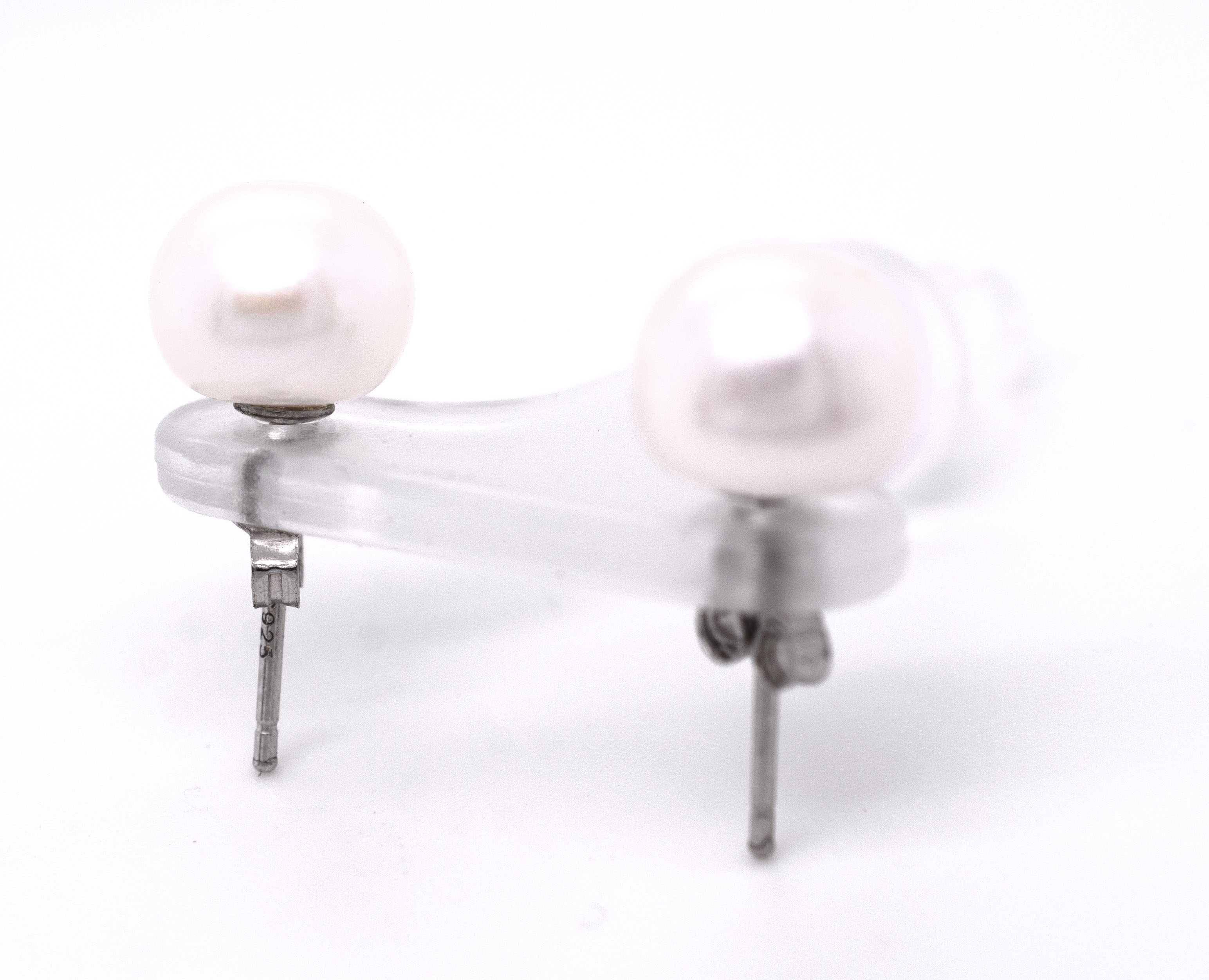 A pair of Classic Pearl Stud Earrings from Super Silver on a white background.