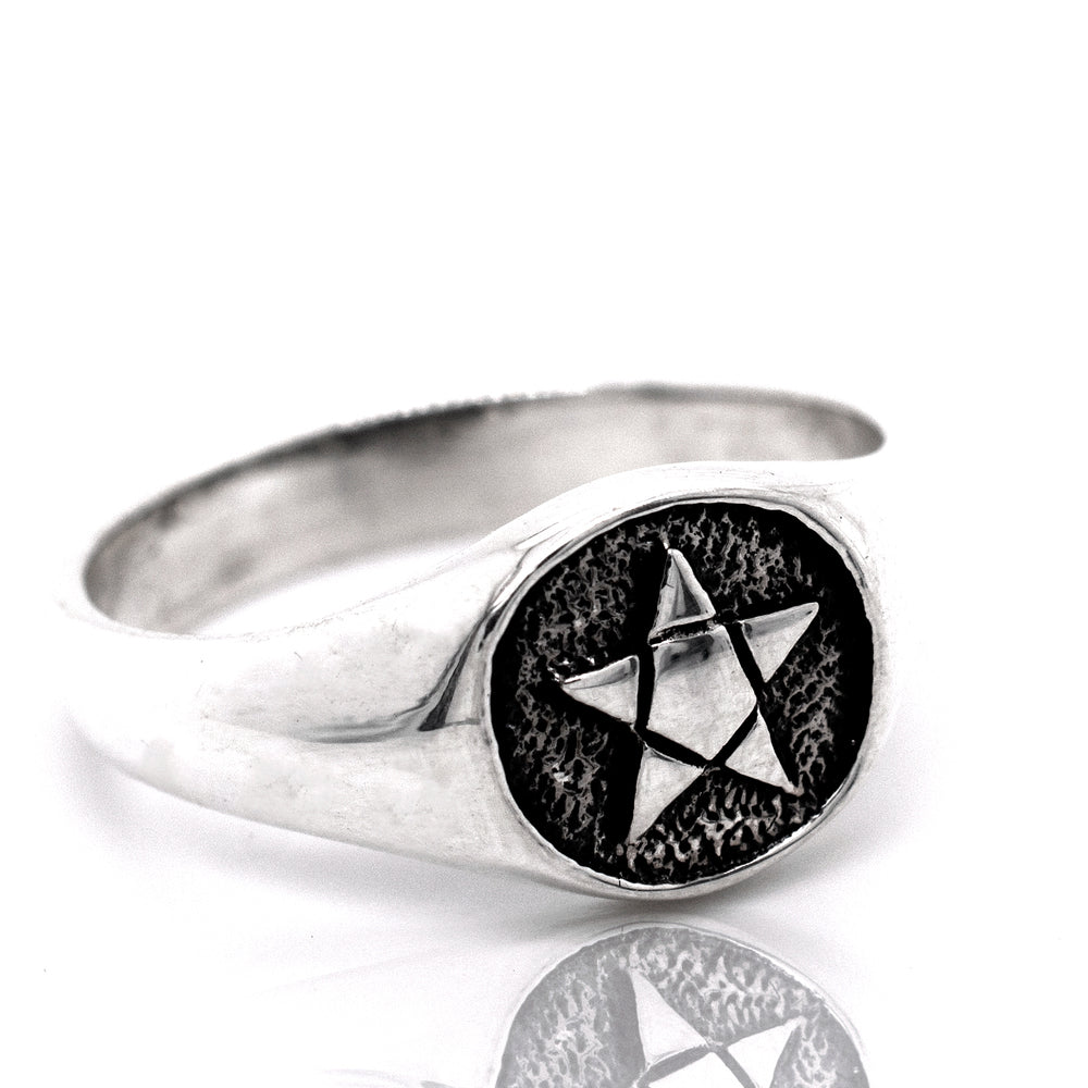 
                  
                    A gothic silver Pentagram Ring with a star on it.
                  
                