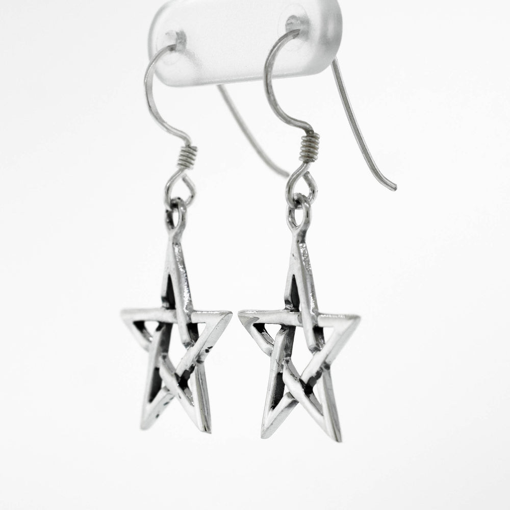 A pair of Super Silver sterling silver pentagram earrings hanging on a white background.