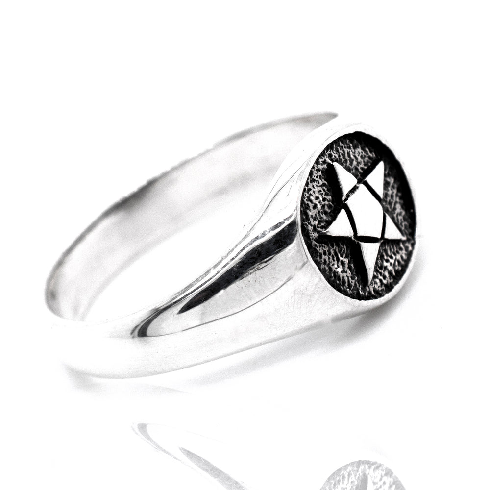 A silver signet ring with a star, perfect for those with a gothic style or a fascination with the Pentagram Ring.