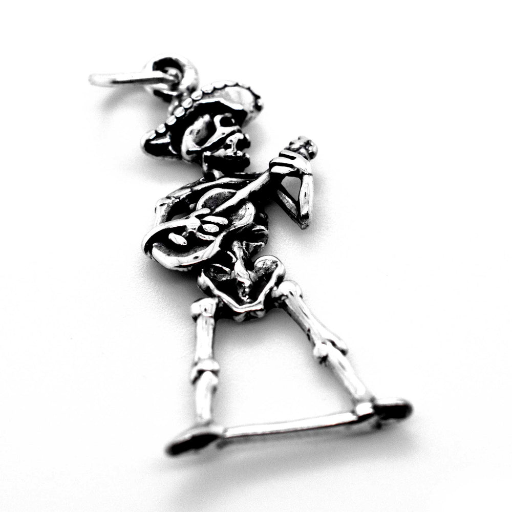 
                  
                    A Super Silver mariachi skeleton with guitar charm on a white background for Día De Los Muertos.
                  
                