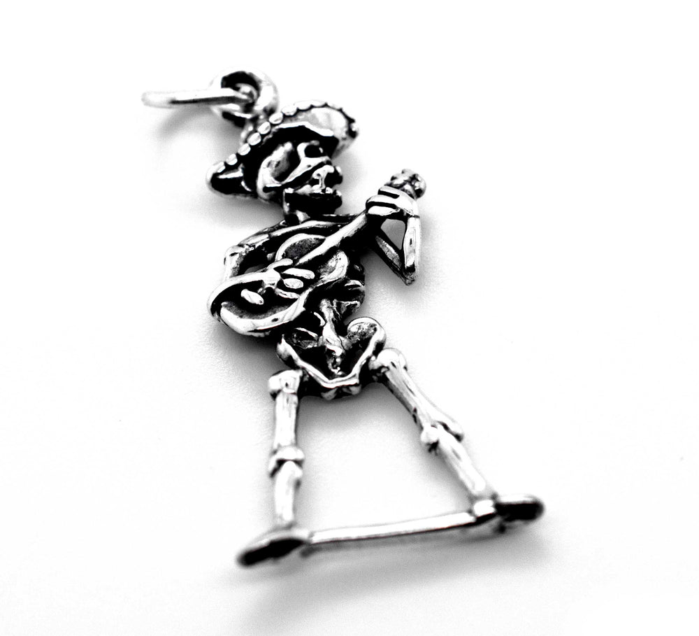 A Super Silver mariachi skeleton with guitar charm on a white background for Día De Los Muertos.