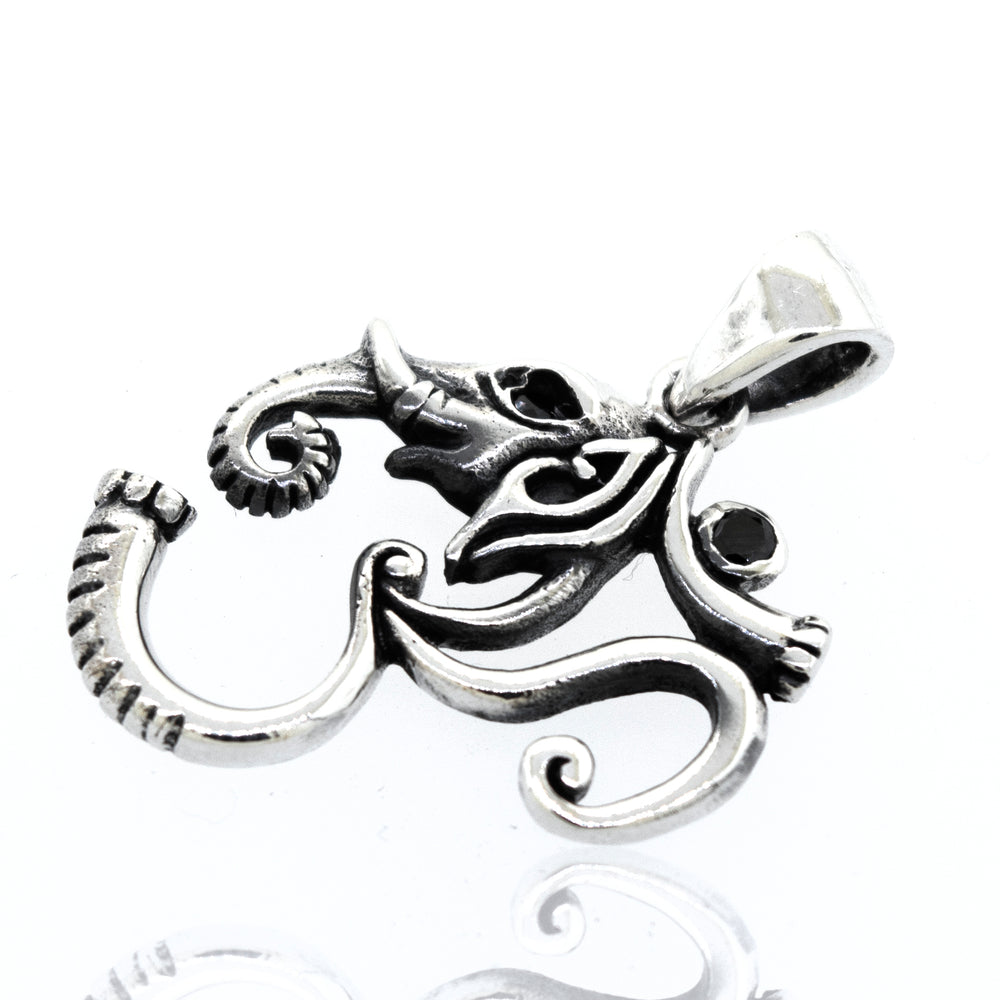 A Super Silver Om Pendant With Elephant Head Design, featuring onyx stones, placed on a white surface.