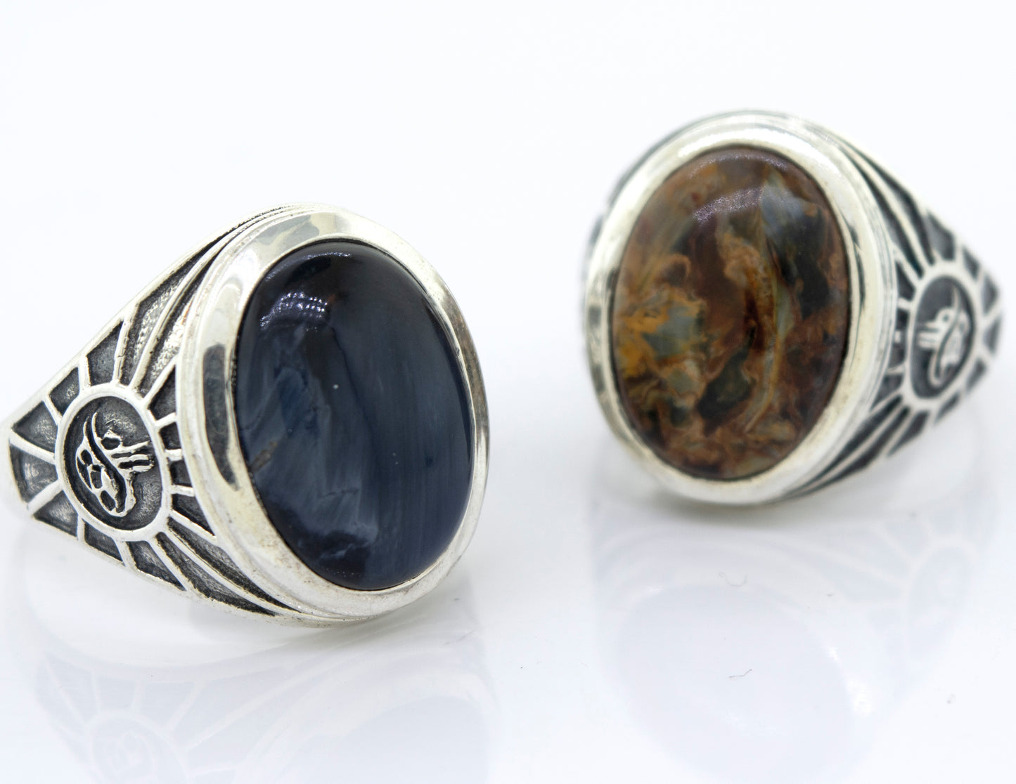 
                  
                    A minimalist Oval Pietersite signet ring with a blue and black stone.
                  
                