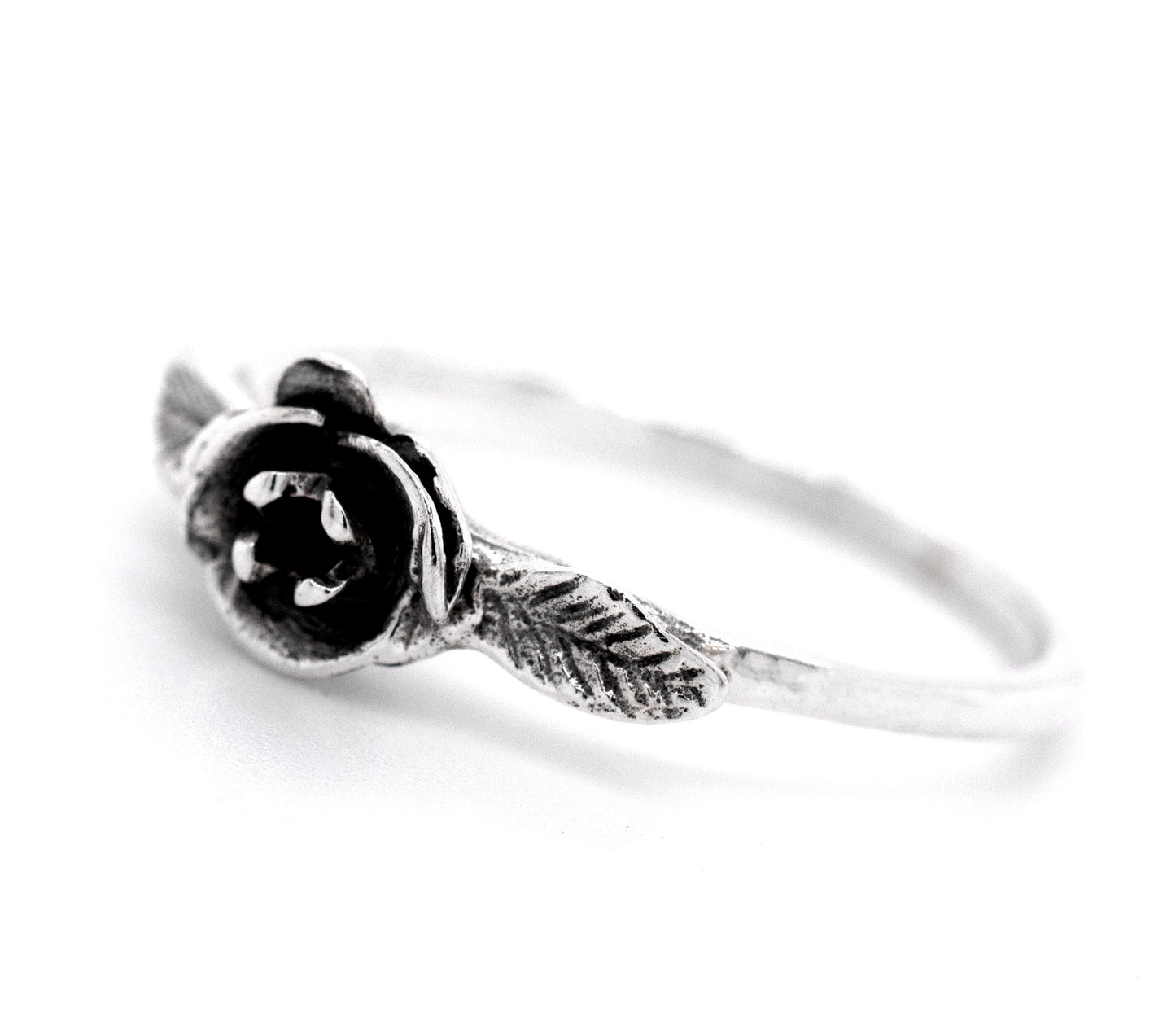 
                  
                    A fashionabe rose ring adorned with a black rose, embracing the floral essence.
                  
                
