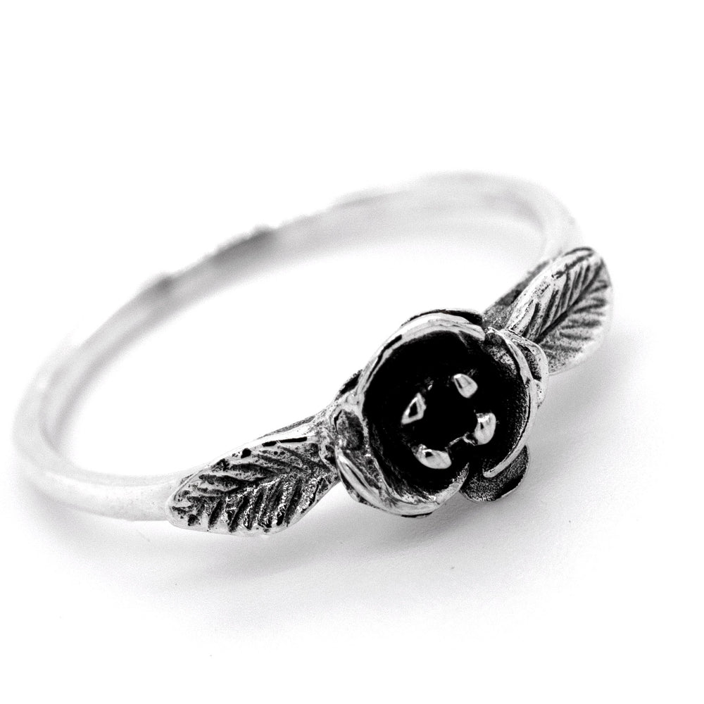 A boho-inspired silver Fashionable Rose Ring adorned with a stunning black rose and delicate leaves, capturing the essence of Santa Cruz's enchanting nature.