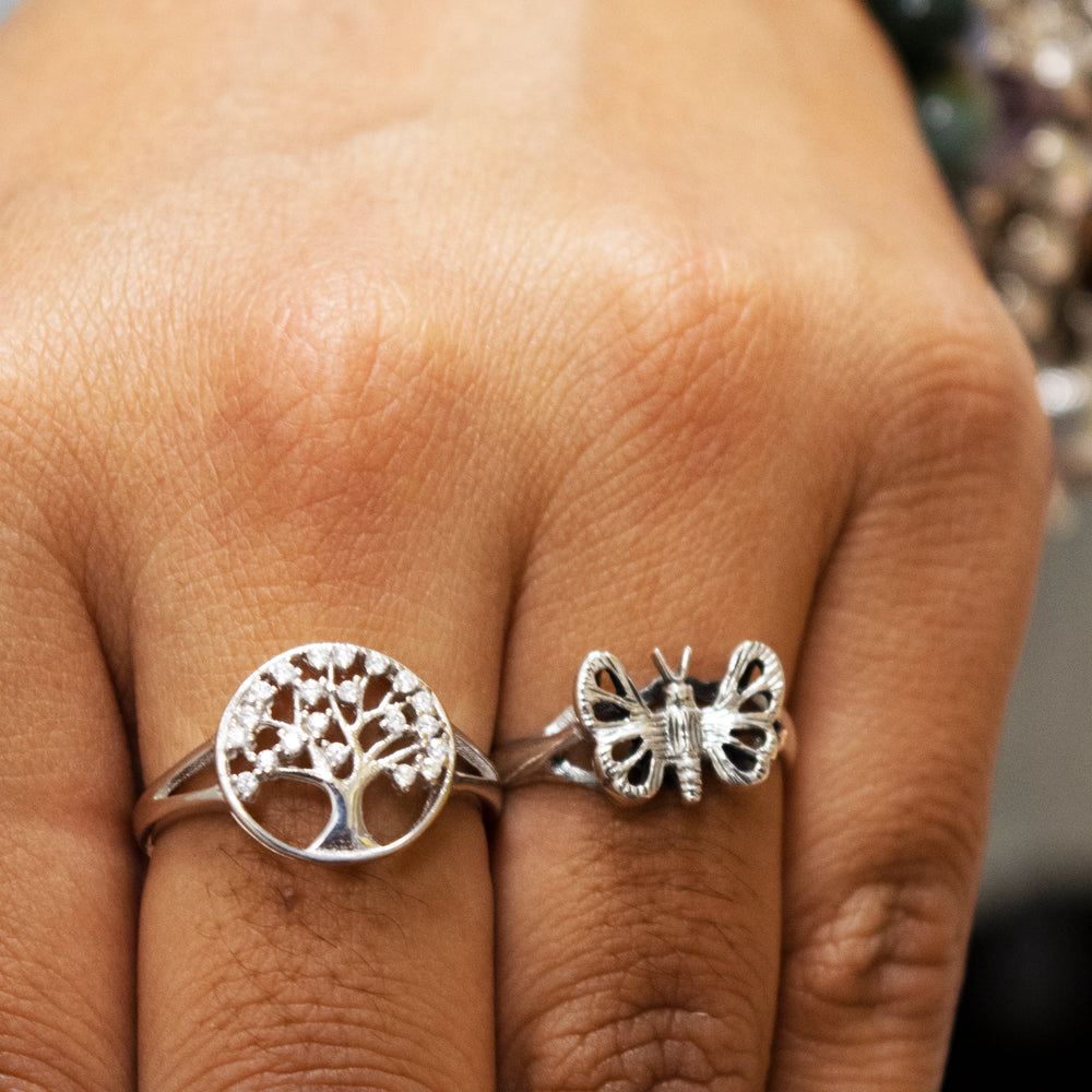 
                  
                    A woman's hand holding a Silver Butterfly Ring, creating a boho statement.
                  
                