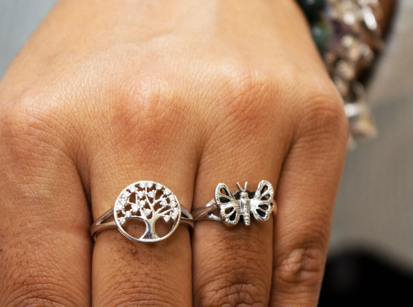 
                  
                    A woman's hand holding a Silver Butterfly Ring, creating a boho statement.
                  
                
