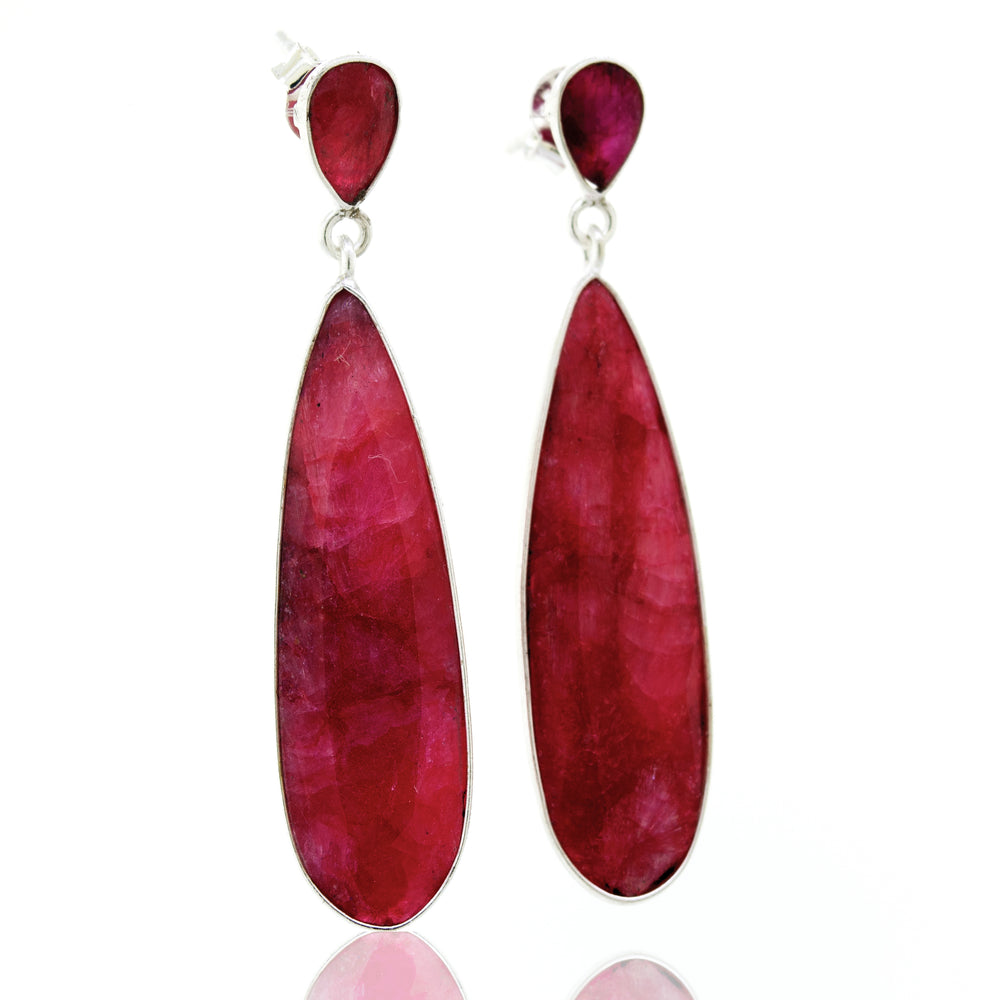 
                  
                    A pair of Super Silver vibrant teardrop shape ruby earrings.
                  
                