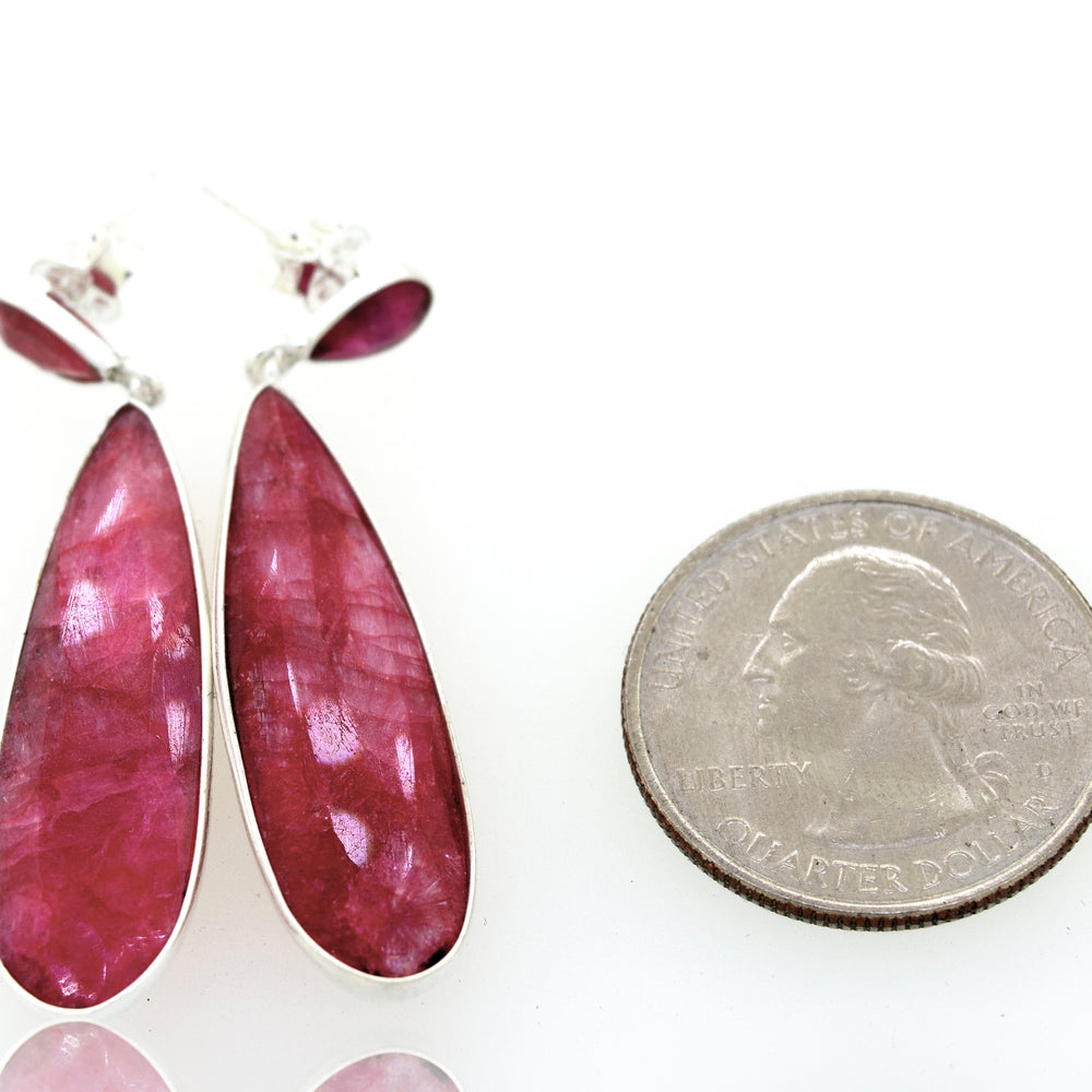 
                  
                    A pair of Super Silver vibrant teardrop shape ruby earrings.
                  
                