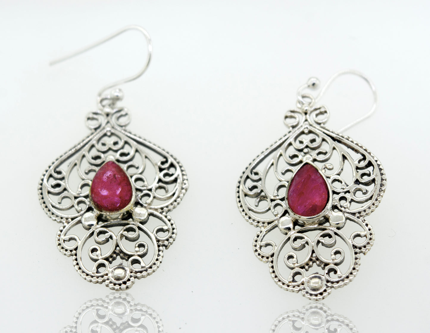 A pair of Super Silver Teardrop Ruby Earrings with a vibrant teardrop-shaped ruby stone set in silver.