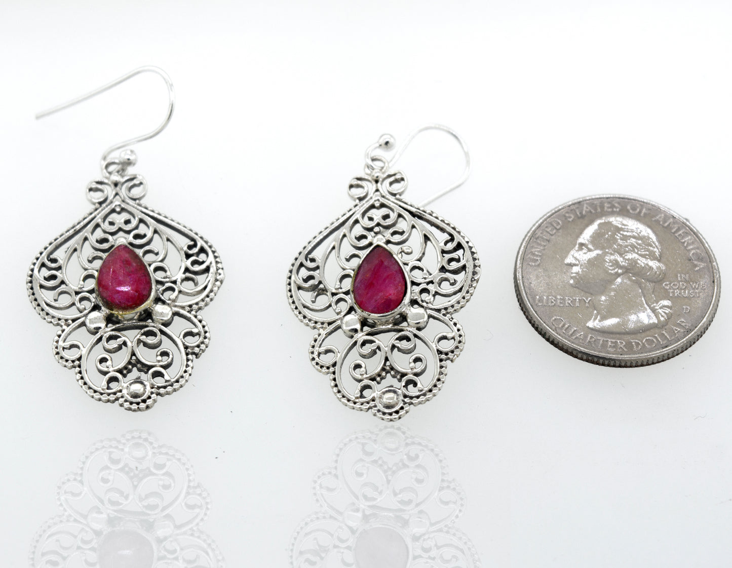 
                  
                    A pair of Super Silver Teardrop Ruby Earrings With Freestyle Silver Design.
                  
                
