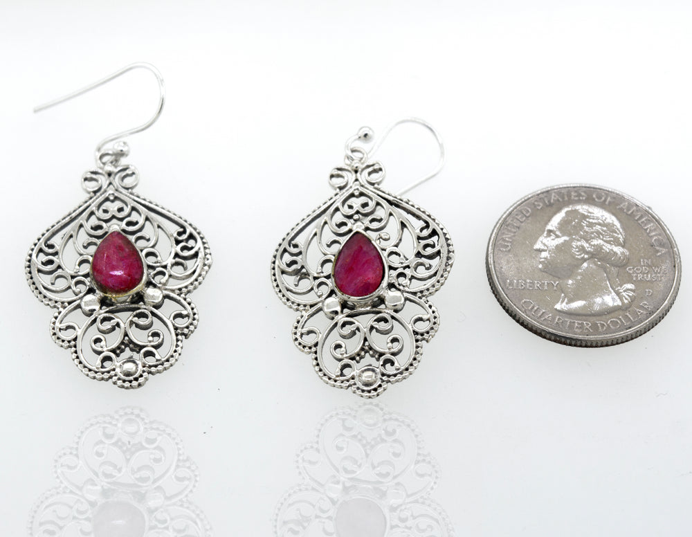 
                  
                    Teardrop Ruby Earrings With Freestyle Silver Design
                  
                