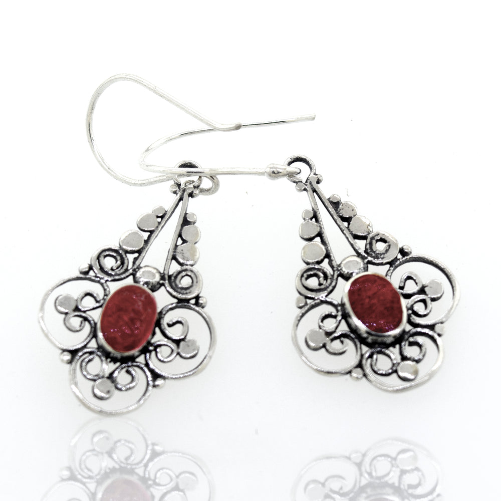 A pair of Oval Coral Dangle Earrings With A Flower Design from Super Silver, with a red stone.