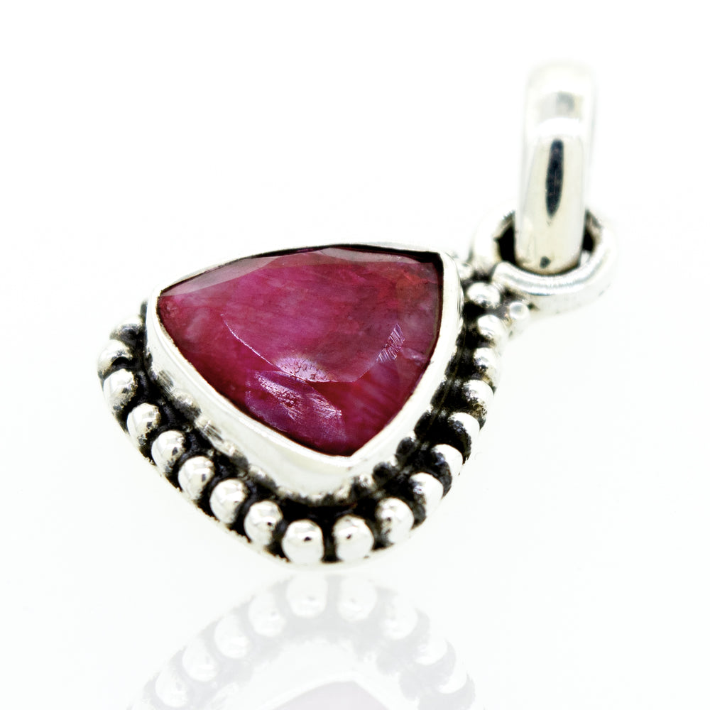 A Super Silver beautiful triangular shape ruby pendant with beads design in a silver setting.