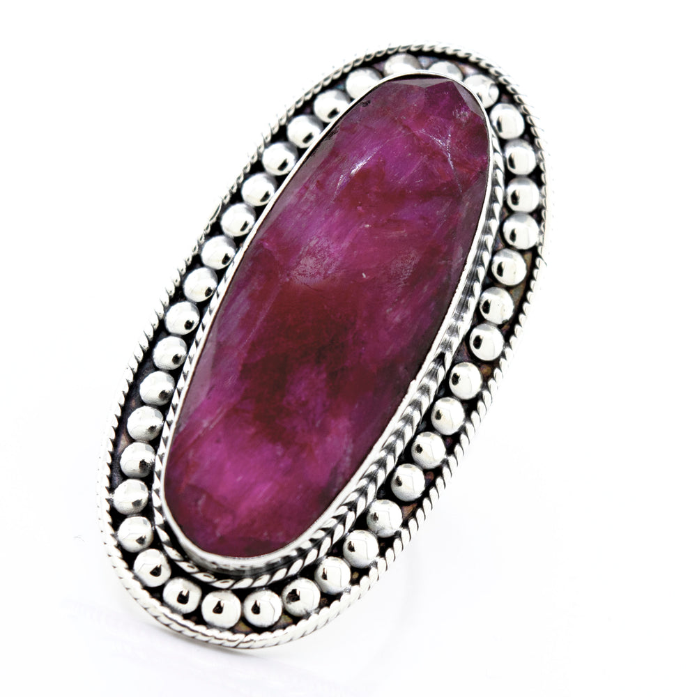 An Elegant Raw Ruby Ring with a pink stone in a Super Silver setting.