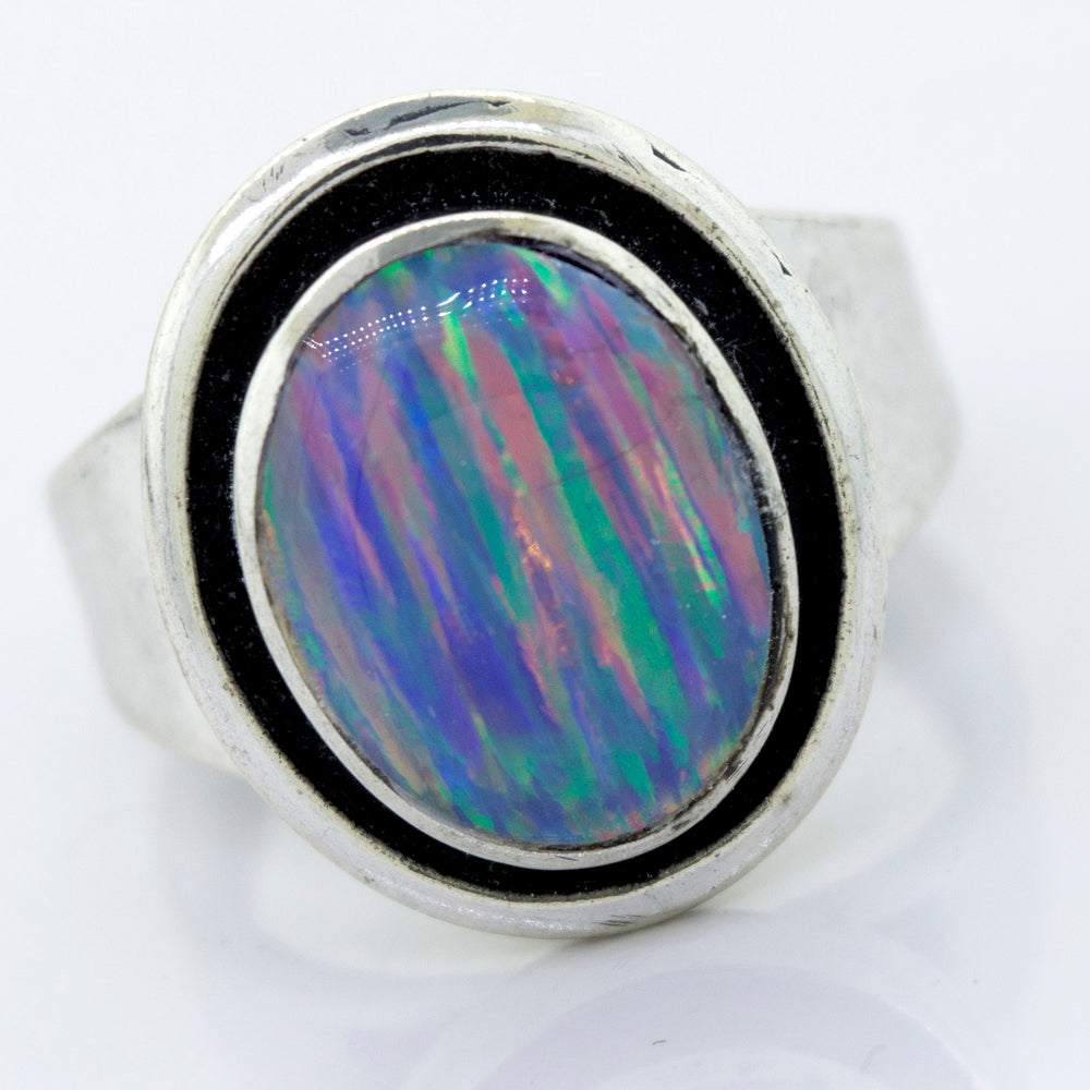 
                  
                    A minimalist silver ring with a Radiant Opal Signet stone.
                  
                