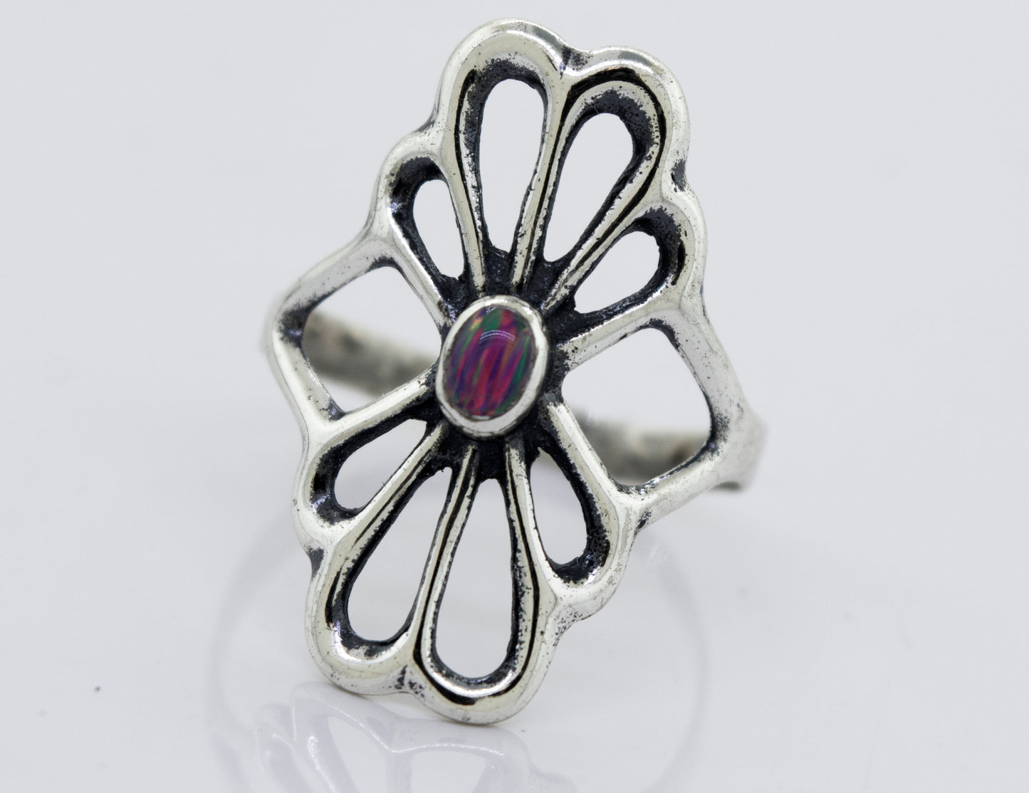 A handcrafted Super Silver American Made Flower Ring with an oval opal stone in the center.