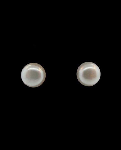 A pair of Classic Shell Pearl Studs by Super Silver on a black background.