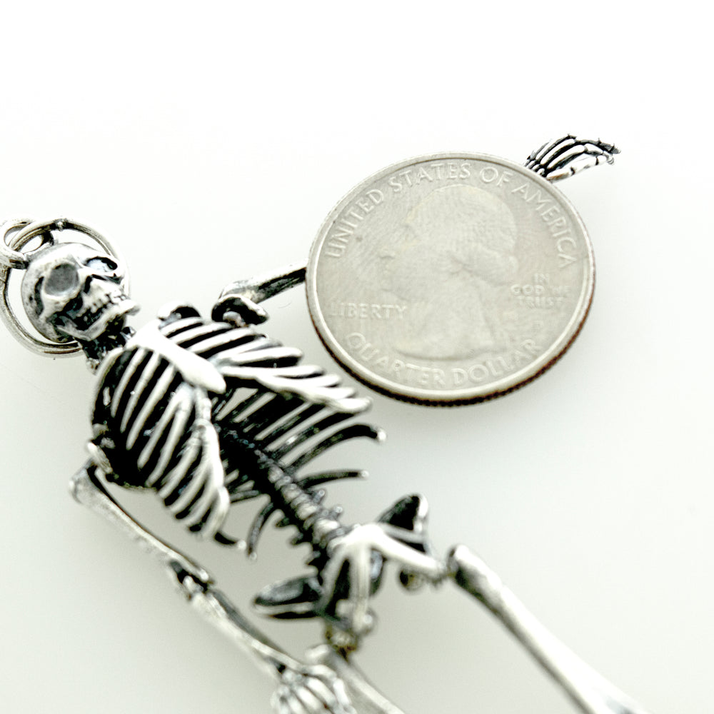 
                  
                    A stylish Large Skeleton Pendant by Super Silver, resting on top of a coin, creating a stunning statement piece.
                  
                