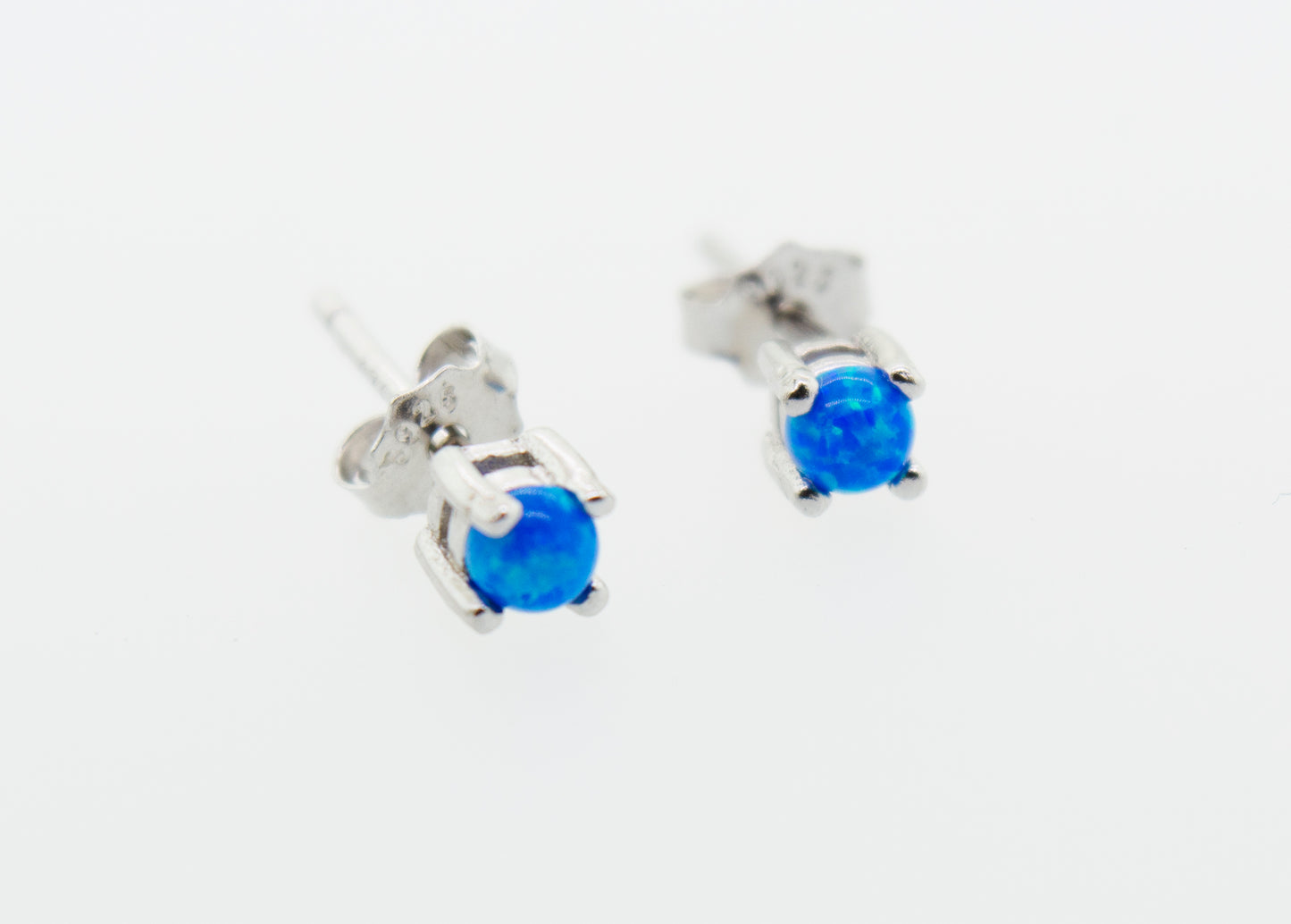 A pair of Super Silver Cultured Opal stud earrings on a white background.
