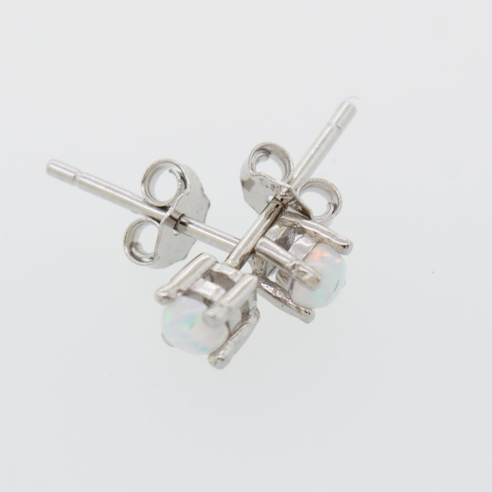
                  
                    A pair of Super Silver Cultured Opal Stud Earrings featuring lab-created opal on a white surface.
                  
                
