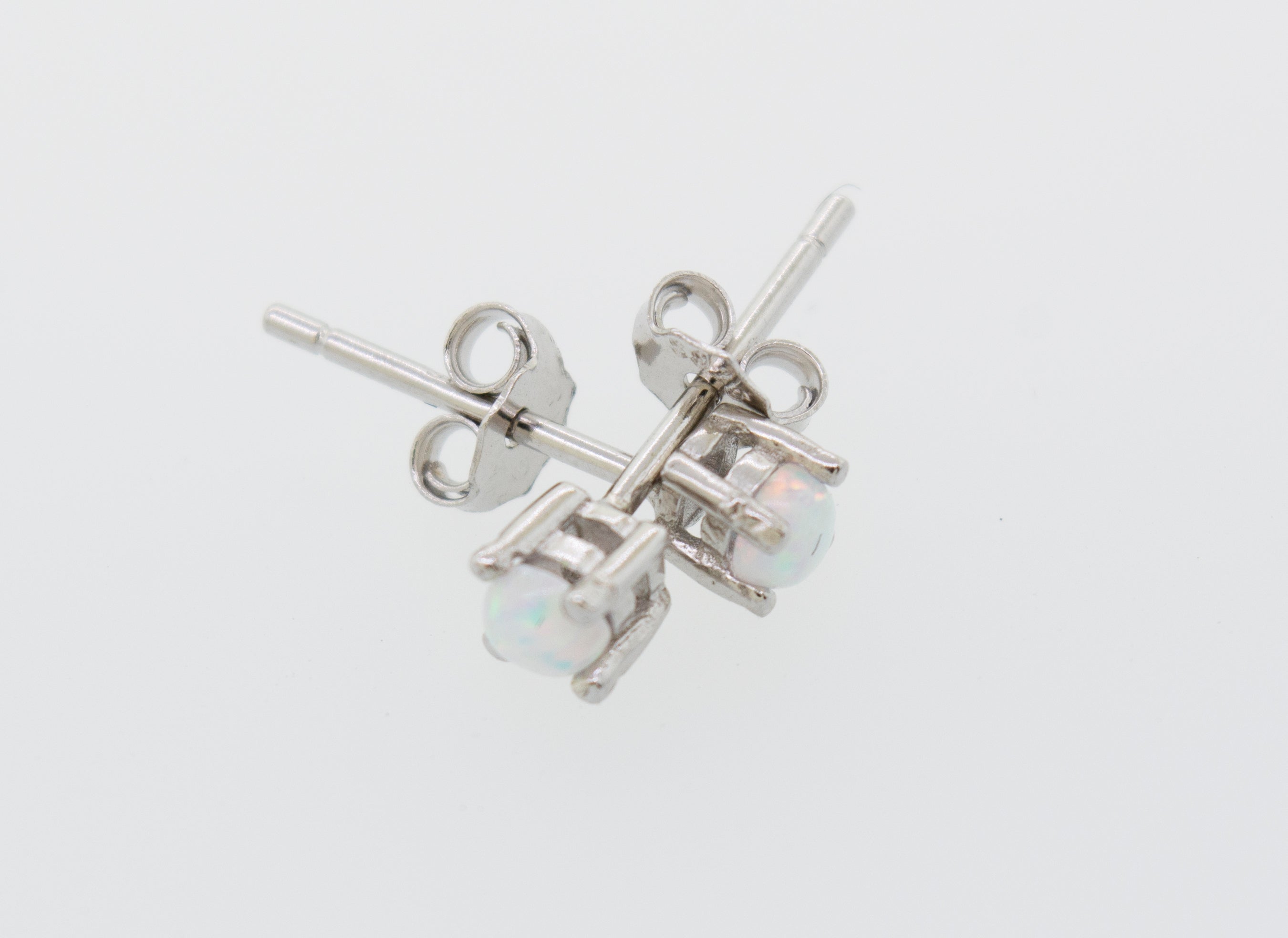 A pair of Super Silver Cultured Opal Stud Earrings featuring lab-created opal on a white surface.