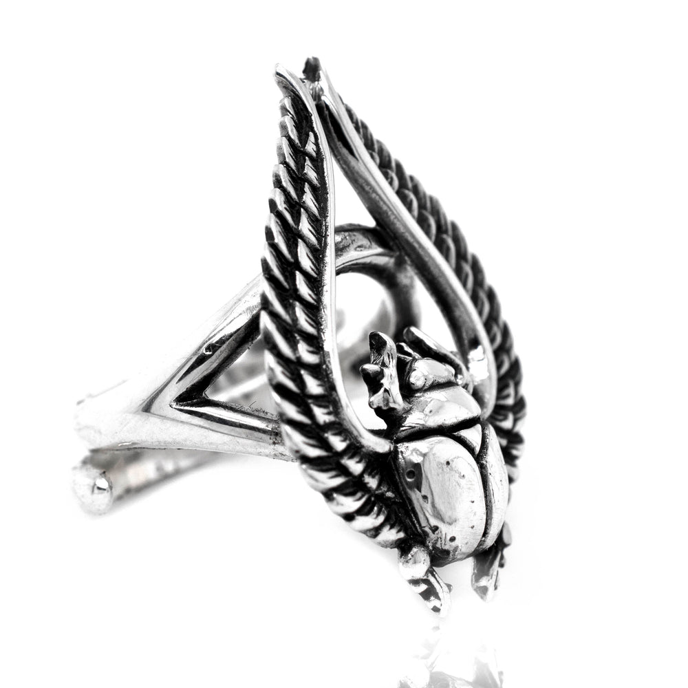 An artisan silver Winged Scarab Ring boasting a striking statement with an Egyptian scarab beetle.