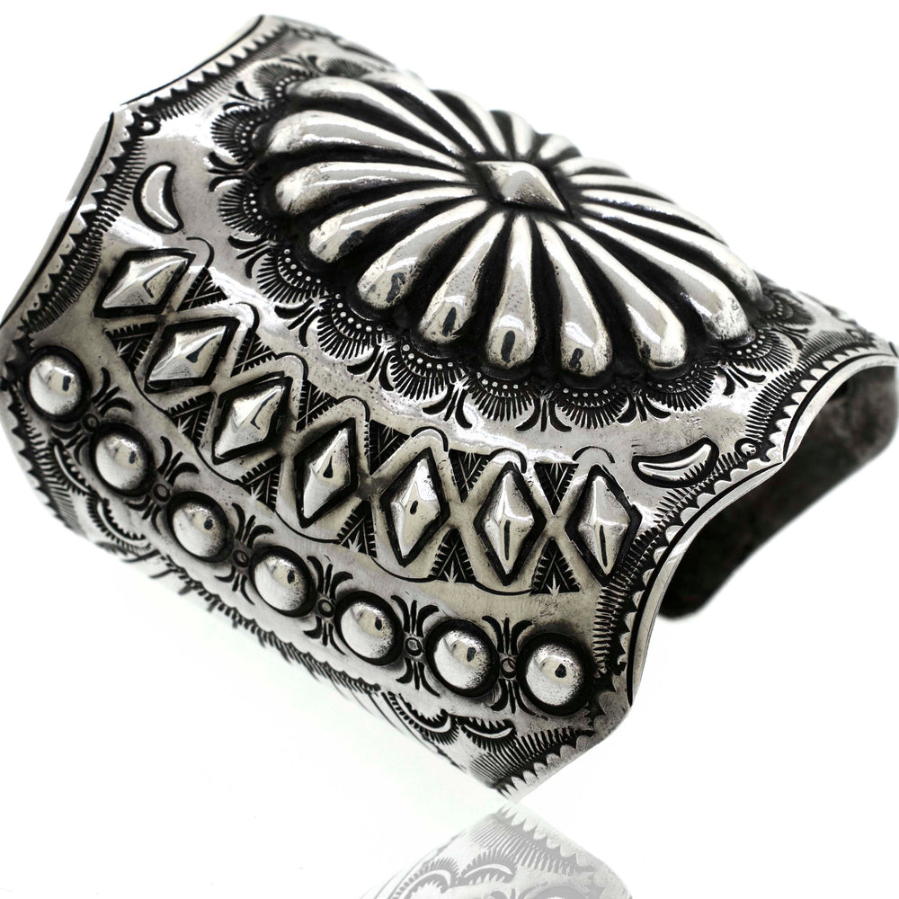 
                  
                    A Super Silver Hand Crafted Silver Concho Cuff bracelet with a flower design, reminiscent of a concho cuff, inspired by the vibrant southwest region.
                  
                