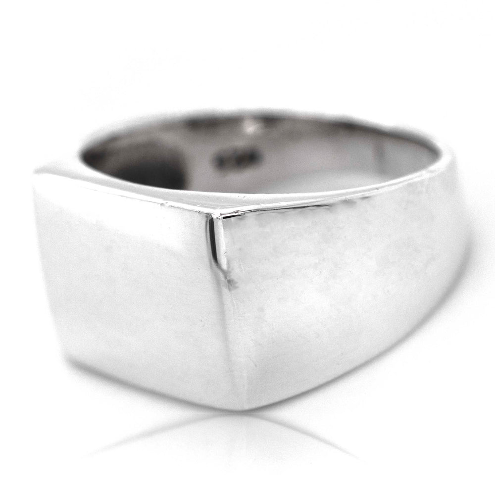 A minimalist silver Signet Ring with a band on a white background.