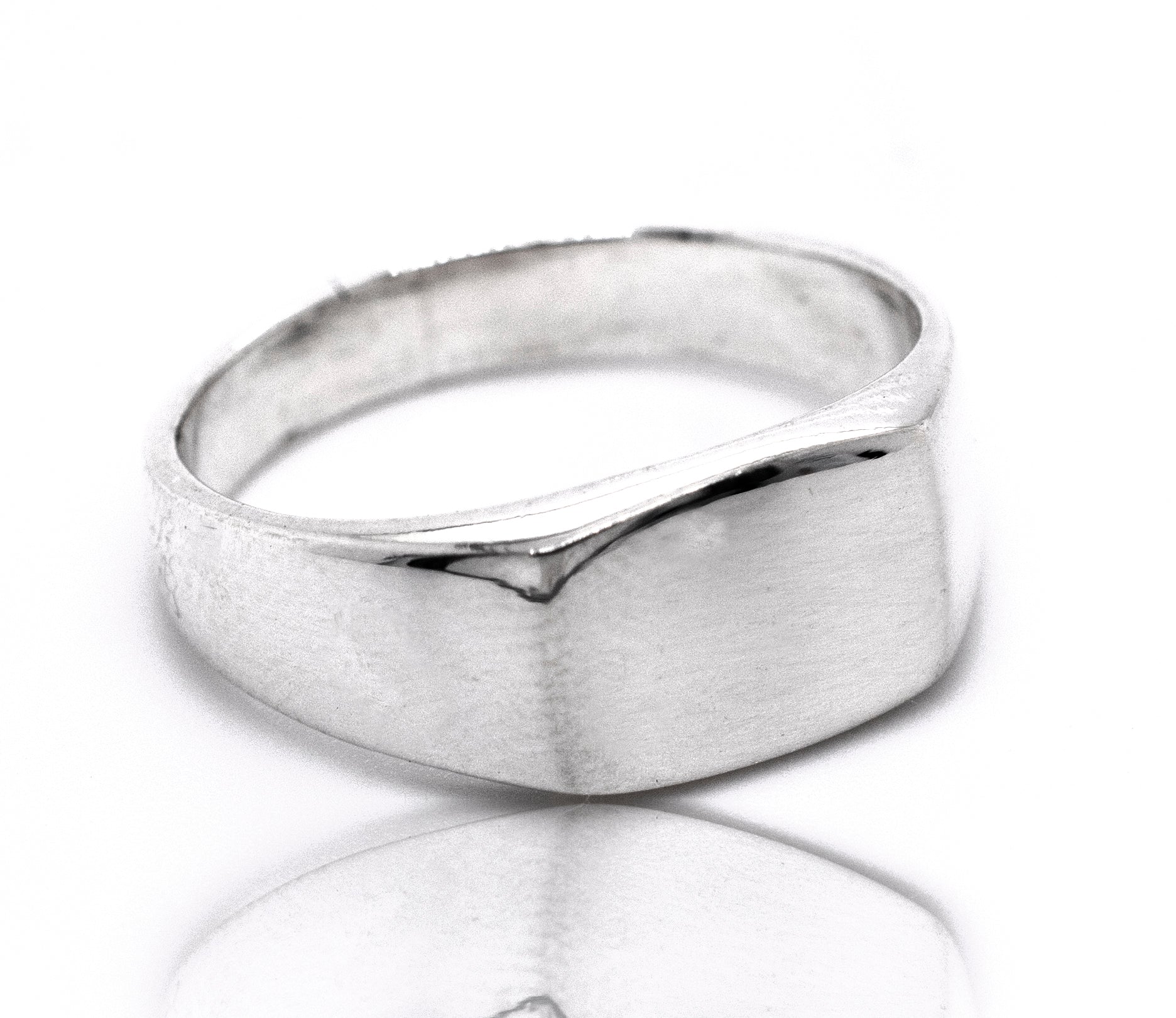 A rectangular signet ring with an engraving on a white surface.