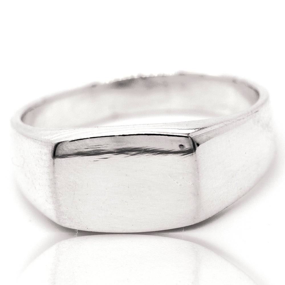 A rectangular signet ring on a white background.
