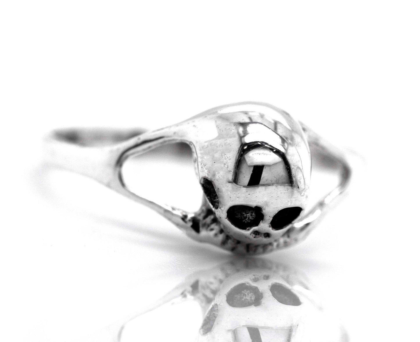 
                  
                    A dainty skull ring on a white surface.
                  
                