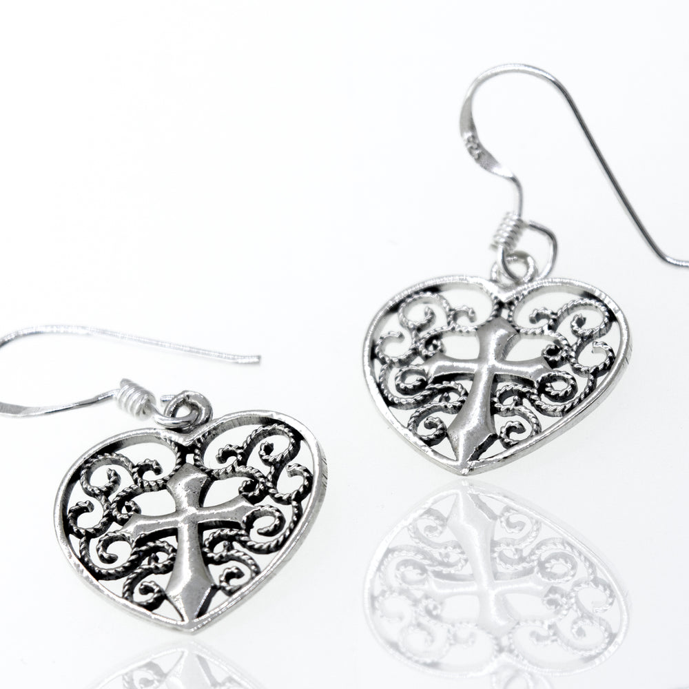 
                  
                    A pair of open Filigree Heart with Cross Sterling Silver Earrings by Super Silver.
                  
                