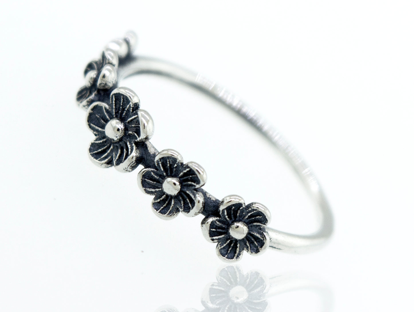 A boho silver Flower Band Ring with black stones.