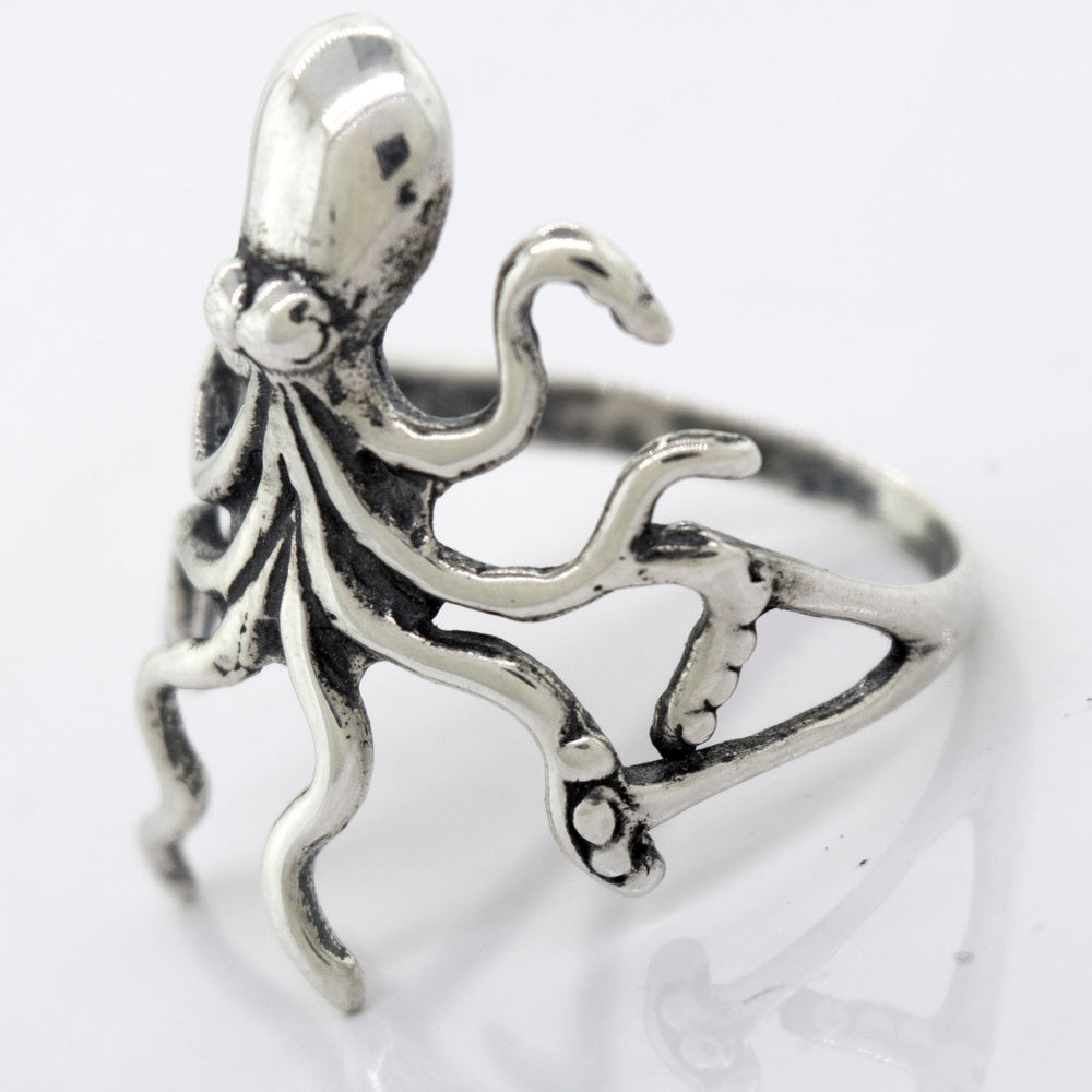 A handmade American Made Octopus Ring by Super Silver on a white surface.
