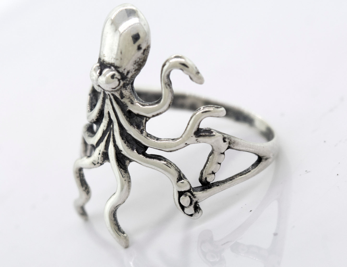 
                  
                    A handmade American Made Octopus Ring by Super Silver on a white surface.
                  
                