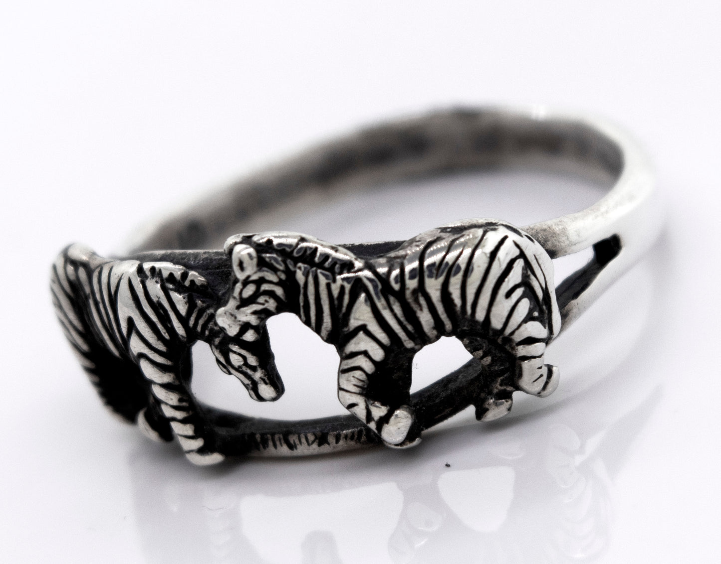 
                  
                    A Super Silver sterling silver ring featuring handcrafted zebras: the American Made Zebra Ring.
                  
                