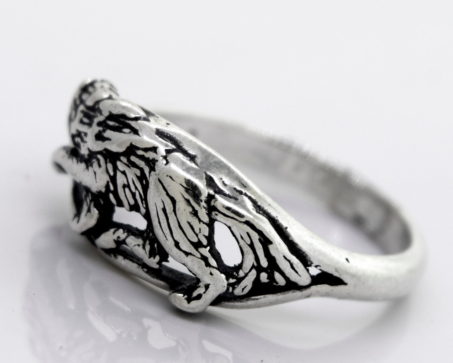 
                  
                    An American Made Prowling Wolf Ring from Super Silver with an image of a lion on it.
                  
                